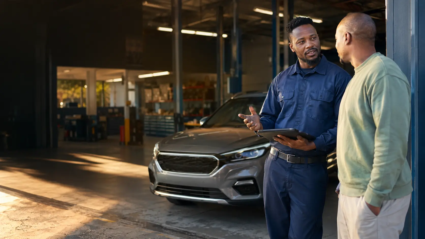 Automotive advisor clearly explaining vehicle work to a customer