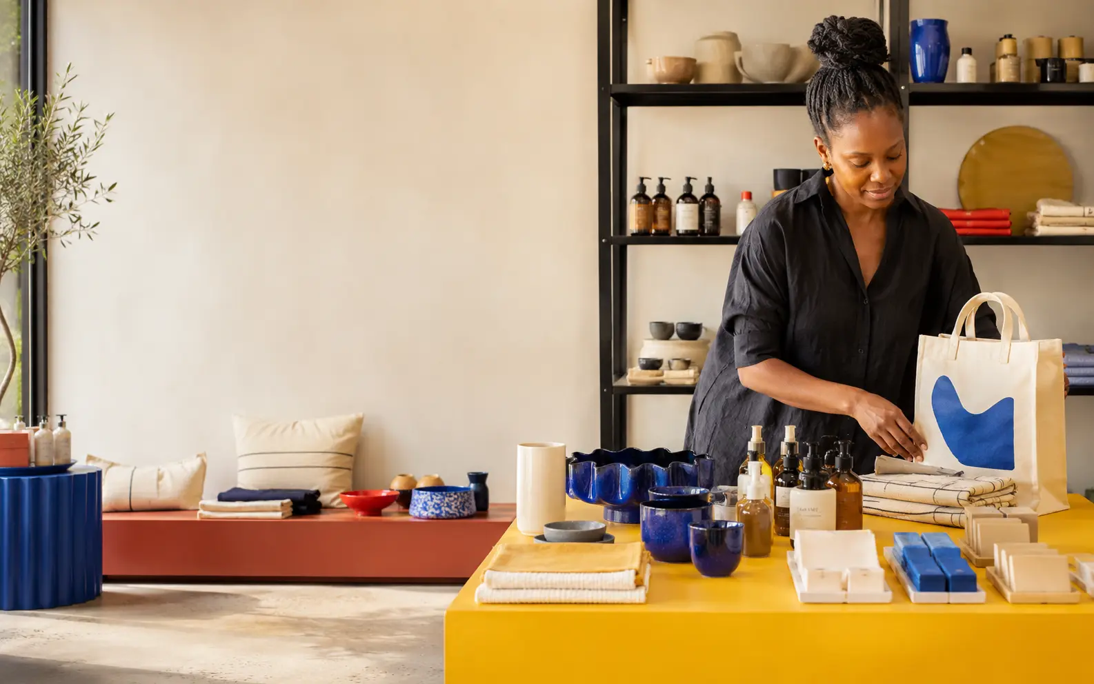 Independent retailer standing in a colourful modern store